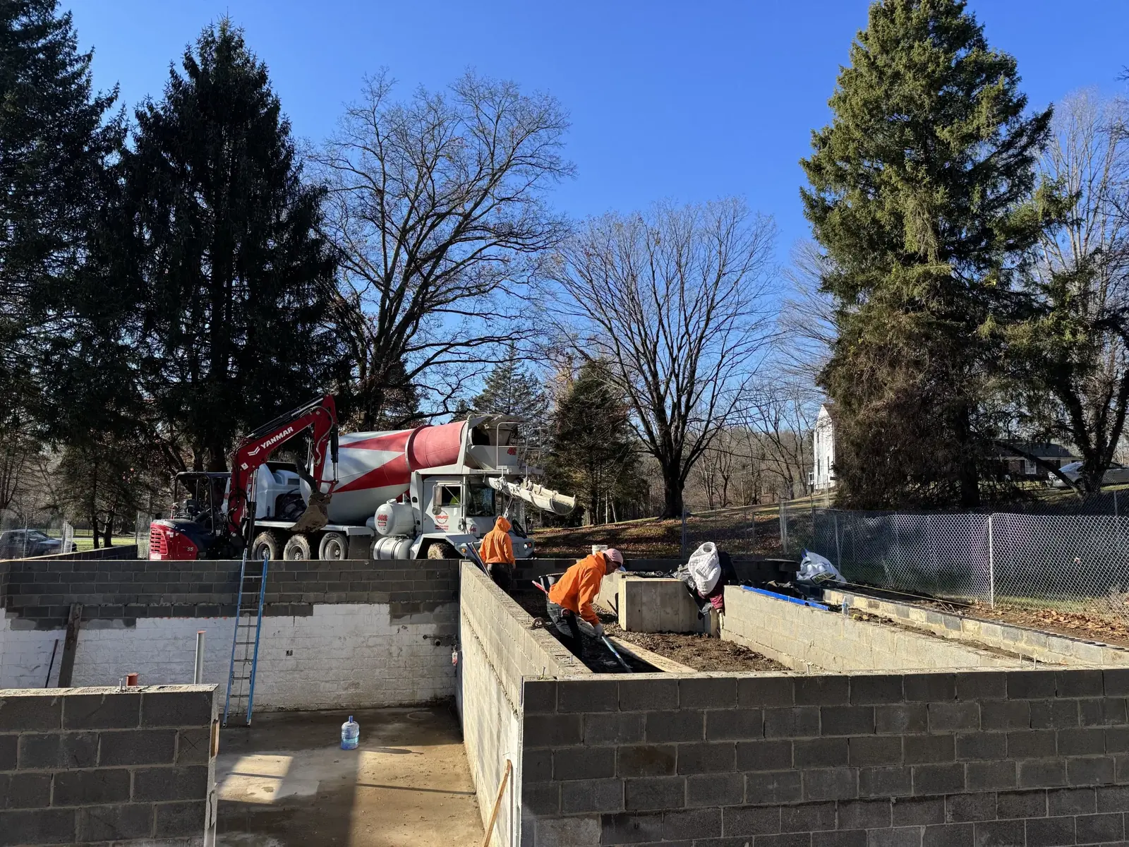 Block foundation walls with a concrete mixer on site