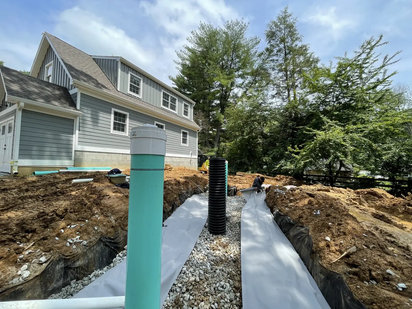 Stormwater basin and inlet installed beside a house